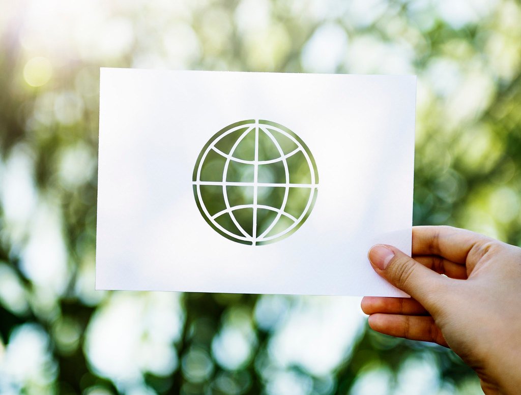 Vasudhaiva Kutumbakam in an Age of Wars: Does Ancient Wisdom Still Work? - Hand Carrying a Piece of Paper of the World